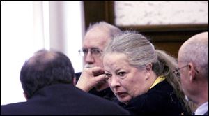 Michael Gravelle looks on as his wife, Sharen, talks to one of the couple s attorneys after the verdict was read yesterday in Huron County Common Pleas Court.
Judge Earl McGimpsey set sentencing for Feb. 12. In addition to possible prison terms, the couple could be fined up to $40,000 each.
