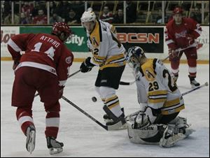 The Storm s Jeff Attard, left, tries to gather in a rebound after a shot on Johnstown goalie Morgan Cey.
