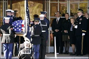 Former First Lady Betty Ford, escorted by Maj. Gen. Guy C. Swan III, watches as the casket of her husband, former President Gerald R. Ford, arrives at St. Margaret's Episcopal church.