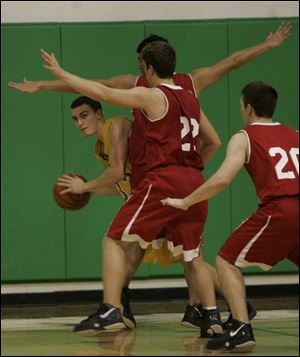 Whiteford' s Nate Seevers is double-teamed by Bedford's Joshua Albright and Matt Drew (22) in the 9th Annual Emmanuel Christian Warrior Classic last night.