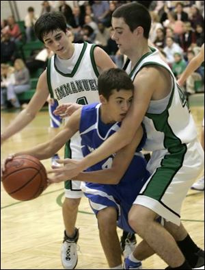 Springfield s Nick Konrad finds himself in a tight spot against Emmanuel Christian s Paul Lawson last night in the Warrior Classic. His Blue Devils won the game, however, and it was
their first victory of the season. Read <a href=http://www.toledoblade.com/apps/pbcs.dll/article?AID=/20061230/SPORTS06/612300444/-1/SPORTS><b> Springfield torches Warriors</b></a>
