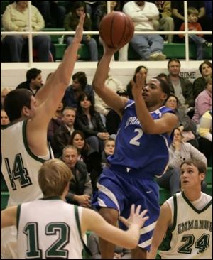 Springfield s Josh Latimer takes a shot over Emmanuel Christian s Paul Lawson.