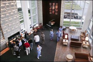 Employees mingle and check out some of the amenities in the lobby of the new, $95 million hospital.
