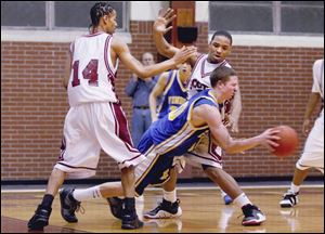 Findlay s Jesse Wohl tries to pass out of the trap by Scott s Irmon Young (14) and Hakeem Greer last night in a battle of unbeaten teams. Scott remained so with a 67-54 victory at home.
