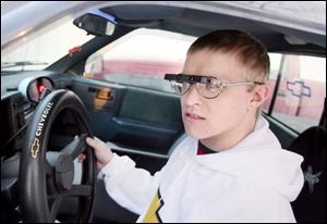 Neil Karns wears a bioptic telescope, a $2,500 device, to overcome his visual impairments. The teenager is legally blind.