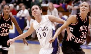 Findlay's Carlee Roethlisberger jockeys for rebounding position against Marion Harding. She leads the 16-2 Trojans in both scoring and rebounding. 