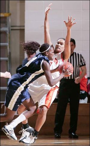 Akron s Riana Miller, from Northview, is fouled on a drive by Bowling Green s Amber Flynn. Miller led Akron with 12 points.
