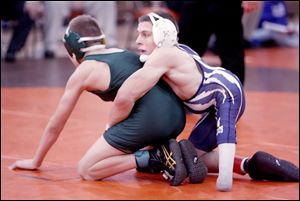 Napoleon's Brad Heinrichs competes against Clay's Josh Witt in the 103-pound division of the Southview Invitational, which Heinrichs won. Born with spina bifida, Heinrichs has had 23 major surgeries on his legs and back. 