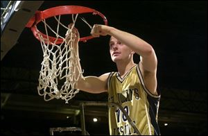 John Floyd helps cut down the nets after scoring 24 points to help St. John s defeat Scott in the 2002 City League championship game.
