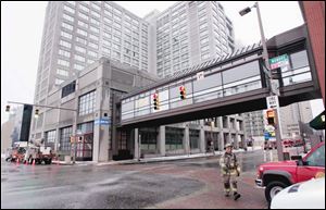 A Toledo Edison crew, left, and the Toledo Fire Department respond to a transformer fi re at the Park Inn. No one was injured.