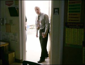 Gary Keller, principal of Kenwood Elementary in Bowling
Green, inspects classrooms during a lockdown drill to ensure students and teachers are following proper procedures.
