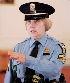 Toledo Police Sgt. Karen Martensen, another honor guard
member, practices for a day she knows will be emotional for her colleagues and the community.
