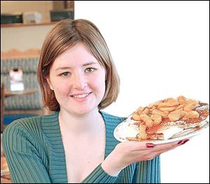 Sarah Herringshaw holds Roasted Caramel Apple Cream Stacked and Stuffed Hotcakes.