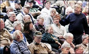Former Fulton Township trustee Roger Bernath, standing, opposes a plan to merge Swanton and surrounding townships. 