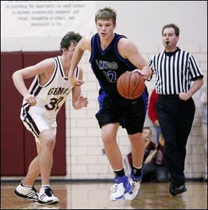 Elmwood's Dustin Reynolds takes off with Genoa's Chris Bassitt trailing. Reynolds, who missed four games because of injury, averages 18.4 points and 8.6 rebounds per game. 