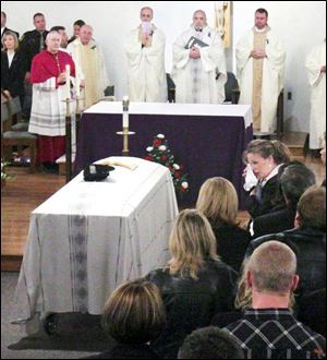 The body of Detective Keith Dressel lies in Our Lady of Mount Carmel Catholic Church, surrounded by his family and members of the community he came from and the one he chose to serve.