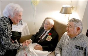Eark Hipster, center, recieves congratulations from his friends Ruth Vandersall, left, and Keith Bradley.