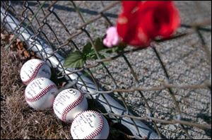Baseballs with memorial messages and names of the
four Bluffton University baseball players who died in Friday s bus crash in Atlanta lie next to a fence near the team s playing diamond in Bluffton.