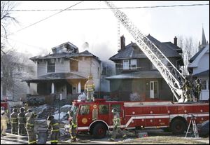 Firefighters battle the blaze at 729 Boalt Street.  Watch firefighters <a href=http://www.toledoblade.com/assets/mpg/TO1326336.MPG><b>battle the South Toledo fire</b></a>.
