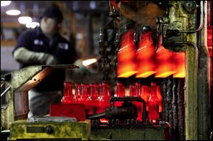 Red-hot beer bottles pour out of the Windsor, Colo., factory's forming machine at the rate of 600 a minute.