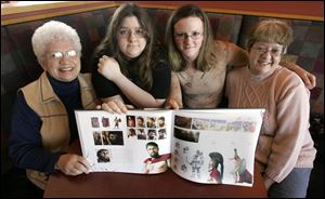 Gerald Butler fans, from left, Doris Dubilzig, Angel Burden, Carlye Seybold, and Cathy White show off the 300 tabletop
book featuring their favorite movie actor, Gerard Butler, at Panera Bread in Rossford.

