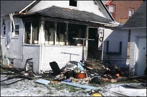 Investigators said an electric heater started the fatal fire in a rear, three-season porch of this home on Burr Street in East Toledo. The accidental blaze caused $50,000 in damage.
