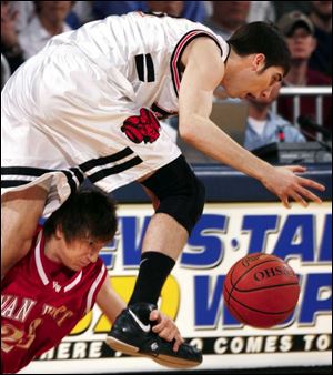 Upper Sandusky's Jon Diebler goes for the basketball while Van Wert's Jared Myers tries to impede his progress.