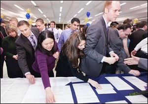 Students from the University of Toledo medical school, the former Medical College of Ohio, pick up their residency assignments. Only 12 of 151 graduates will stay in northwest Ohio.
