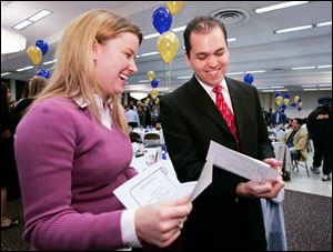 Natalie Singer of Cincinnati and David Majors of Walnut, Calif., compare assignment letters for their medical residencies. The two students are among the 151 who will graduate soon from the University of Toledo medical school, the former Medical College of Ohio. All of the students received their residency letters yesterday. Ms. Singer will be at the University Medical Center at UT; Mr. Majors will be in Texas.
