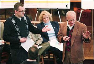 City council member Frank Szollosi, left, holds a document while Carty Finkbeiner makes a point.