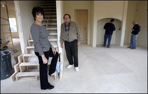 Laurie Melchior Huskisson and her father and mentor, Jerry Melchior, pause during a check-in at one of their firm's projects.