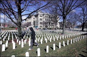 More than 3,000 grave markers planted in the Lucas County Courthouse lawn honor the war's fallen. 