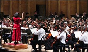 Elizabeth Hamaker conducts during rehearsal of the combined Toledo Symphony and Toledo Youth Orchestra.