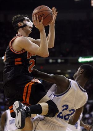 Upper Sandusky s Jon Diebler, broken nose and all, soars to the net on his way to 48 points, third-most ever in the state tournament.