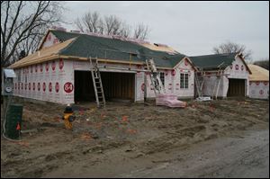 biz build25p  3_21_2007 photo by herral long  workers   were  off  because of rain  note the weather was bad and there was no work going on outside  i did run into the builder Dave Filas   419 360 8815  -- and they were working inside one of the homes  putting down carpet.  Need stand-alone art for Sunday business section. Get various  shots of workers-- hopefully -- building houses at the new subdivison,  the Village at Laurel Hills ______________