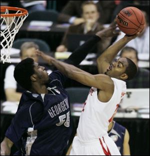 Ohio State's Ron Lewis goes to the basket against Georgetown's Roy Hibbert in last night's NCAA semifinal. Lewis had nine points for the Buckeyes (35-3), who will play for the national title tomorrow night. The only NCAA title in OSU history was in 1960.