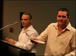 Bill Morgan, right, manager of Vamps, offers a Vamps program to a councilman. Owner
Akrum Youssef, left, said,  Our problem is the outside, the people when they leave. 