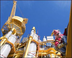 A government report says that natural-gas supplies last month were down from a year ago but still higher than normal.