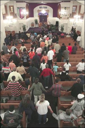 People join hands in prayer at Upton United Methodist.
