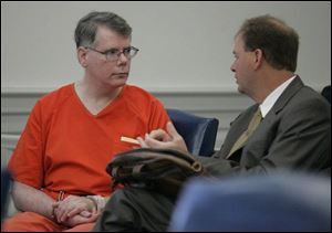 Michael McHugh, left, talks with attorney Greg Bakies before McHugh is sentenced for stealing more than $400,000 in electronics equipment from BGSU.