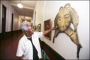 Alice Grace used a jig saw to help make the huge mask that hangs outside her studio at the
Collingwood Arts Center.
