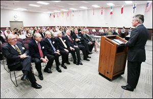 Albert Stroucken addresses the first shareholder meeting to be held in Owens-Illinois' new Perrysburg headquarters. 