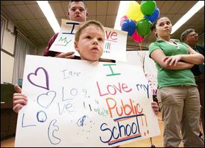 Tyler Wiley, 14, and his brother Steward, 5, both students in Toledo schools, help out.
