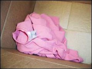 This pink sweater also was found in the cardboard box with the baby boy.