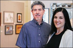 Robert Garcia, left, and Leslie Adams are the judges for the Art-A-Fair exhibit at the Main Library.
