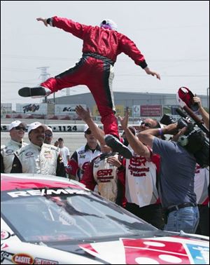 Ken Butler leaps into his crew's arms after winning the Hantz Group 200 in the ARCA RE/MAX
series yesterday at Toledo Speedway. Had he jumped into the crew of Ken Schrader he probably would have hit the ground.