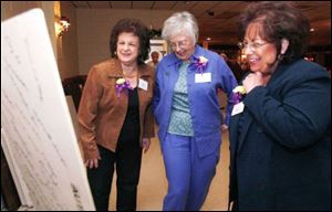 Rose Dinardo Giese, left, who graduated in 1945, Janet Mills, center, whose husband attended Waite, and Shirley Norton, Ms. Giese s daughter, share a laugh while looking at a white-board display adorned with alumni signatures on its back.
