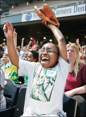 With fan support like this, how can the Toledo Mud Hens
ever lose? An exuberant Zoe Rayford, 10, from Whittier
School was in the crowd that saw the Hens defeat Charlotte, 6-5, yesterday. 