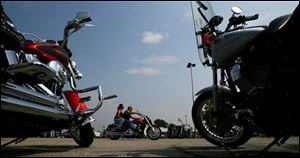 Motorcyclists arrive in Sandusky, Ohio, Friday, June 1, 2007, for Ohio Bike Week, a 10-day motorcycle rally based at the Erie County Fairgrounds.  Many of the bikers started in this parking lot behind the Roeder Harley Davidson dealership which held a 
