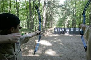 With a steady hand and a steely eye, Matt Mochon, 14, pauses before sending an arrow flying to the target during archery lessons, one of the many activities at the celebration. He is a member of Troop 154.